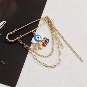 Detailed view of evil eye brooch with colorful heart pendants and golden metal chains