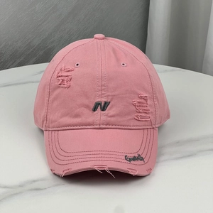 Detailed view of the pink distressed cotton baseball cap with embroidered letter N design