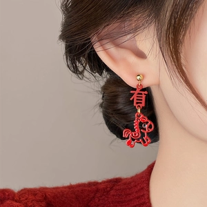 Red horse pendant earrings with character detail for women on red knitwear background