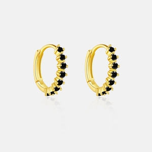 Detail of gold hoop earrings featuring a row of black sparkling zircon gemstones