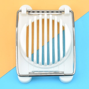 Detailed top view of a white plastic egg slicer with metal cutting wires on a dual-tone base