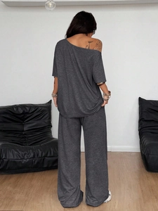 Detail view of the knitted fabric texture and back cut of a grey wide-leg lounge set