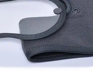 Detailed close-up of dark grey polar fleece material with stitching and snap button