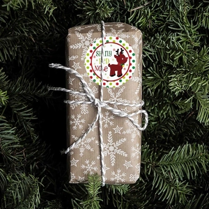 Christmas roll stickers featuring reindeer design on snowflake kraft paper gift wrap