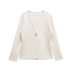 Detail of a cream knit cardigan featuring a V-neck and a polished gold metal button accent