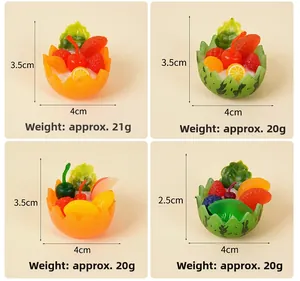 Detailed view of mini resin fruit salad bowls featuring watermelon and orange designs