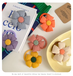 Detail of colorful fabric flower hair ties with elastic bands in various soft pastel tones