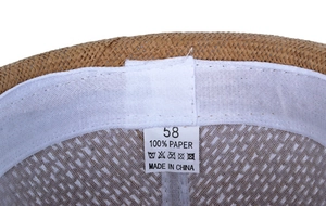 Detail view of woven straw hat interior featuring a size 58 label and sweatband