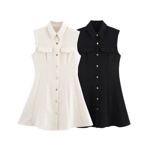 Detail of sleeveless shirt dresses in black and white with gold buttons and lapel collars