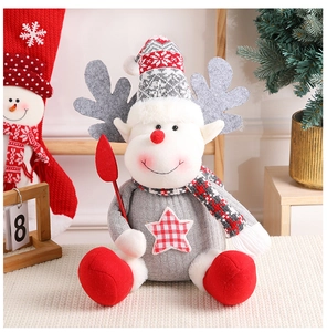 Detail of Christmas reindeer plush doll with knitted hat and plaid scarf for holiday decor