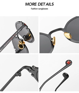 Detail view of gothic punk sunglasses with golden nose pads and red cross temple tips