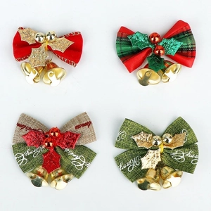 Detail of four festive Christmas bows with golden bells and holly leaves on white background