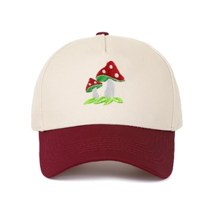 Close-up of mushroom embroidery on a two-tone baseball cap with contrast brim stitching