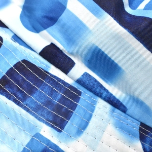 Close-up of premium stitching and blue checkered fabric texture on bucket hat