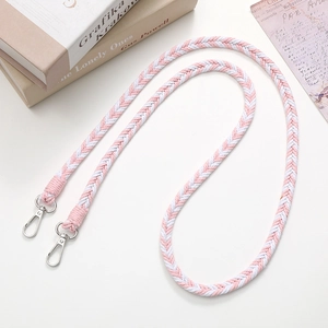 Detailed view of pink and white braided crossbody phone strap with silver metal clasps