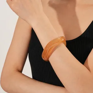 Fashionable amber resin geometric square bangle with natural marbled texture on model