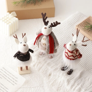Three handmade wool felt Christmas reindeer figurines in knit sweaters for festive home decor
