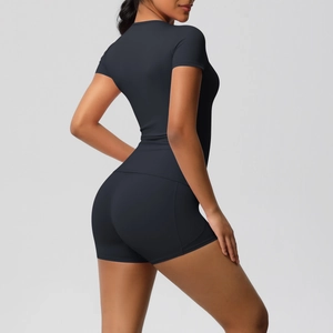 Side view of black brushed nylon yoga set featuring slim fit tee and high waist shorts