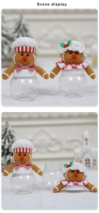 Close-up of plush gingerbread man candy jars with festive chef hats and transparent bodies