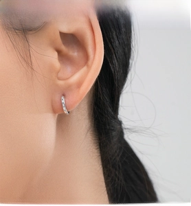 Close-up of S925 sterling silver hoop earrings with cubic zirconia on a model's ear