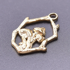 Close-up of golden mushroom pendant with branch hexagon frame and 18k gold plating