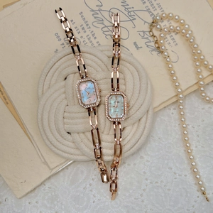 Elegant rose gold square watch with mother-of-pearl dial and diamond-set chain strap