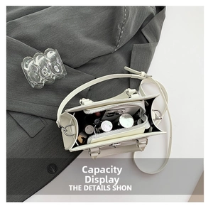 Top view of cream white crossbody bag showing interior compartments and daily essentials