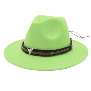 Detail of neon green fedora hat featuring western bull skull charm and studded leather band