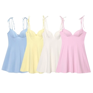 Detail of summer mini dress showing bow-tie straps and sweetheart necklines in pastel colors