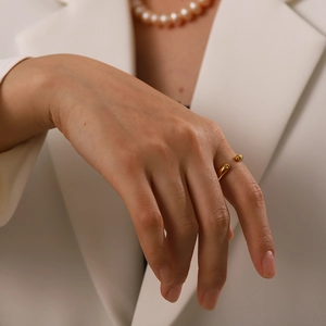 Elegant gold-plated stainless steel open ring with spherical tips worn on hand