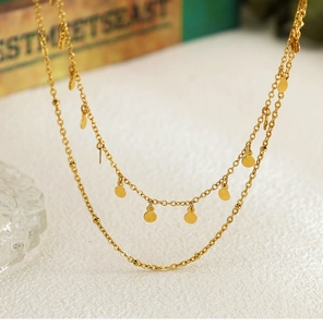 Detail of 18K gold-plated double-layer necklace with spotted geometric round discs