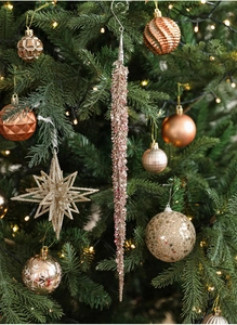 Close-up of champagne and pink gold glitter iced branches hanging on a Christmas tree