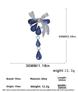 Broche nœud en cristal bleu avec pendentifs goutte et dimensions 65mm par 30mm
