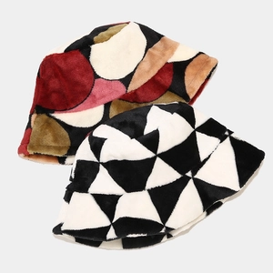 Detail of warm plush bucket hats featuring colorful polka dots and geometric patterns
