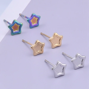 Detailed view of polished star-shaped stainless steel stud earrings in three metallic colors