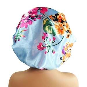 Floral satin sleep bonnet in light blue with wide band and soft hair care protection