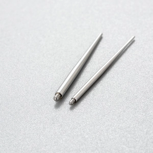 Pair of stainless steel piercing taper tools with threaded ends on a grey background