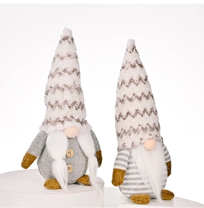 Close-up of two Christmas gnomes with grey knit bodies and tall beige textured hats