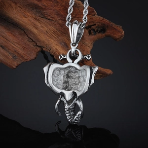 Hip hop elephant head pendant necklace in silver stainless steel on wood and black surface
