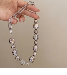 Detail of silver irregular beads and chunky chain on the French style necklace