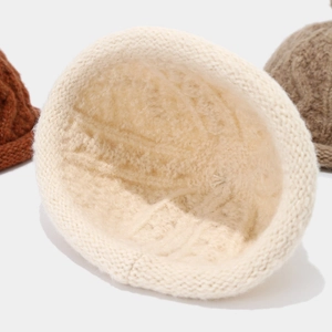 Detail of thick fleece lining and chunky cable knit texture of a warm winter beanie