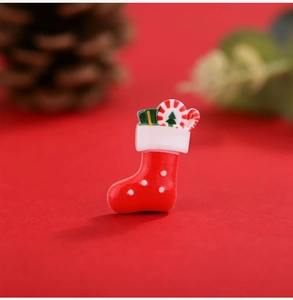 Macro view of a red resin Christmas stocking DIY accessory with miniature gifts and candy