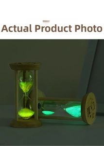 Close-up of wooden sand timer with fluorescent green luminous sand in a dark environment