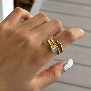 Golden heart zircon wrap ring with spiral band design shown on woman's hand