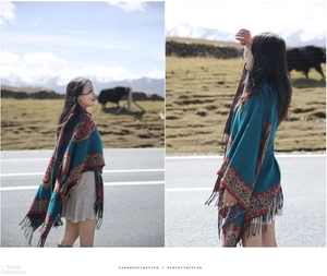 Close-up of bohemian blue paisley shawl with elegant black tassels for outdoor travel