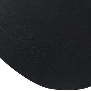 Macro detail of the black cotton baseball cap brim with four rows of reinforced stitching
