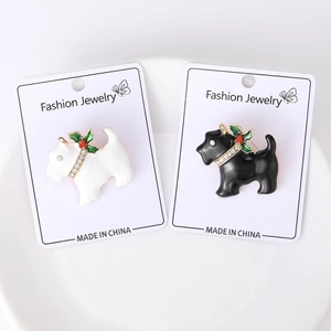 Detail of black and white enamel Scottish Terrier brooches with crystal holly accents