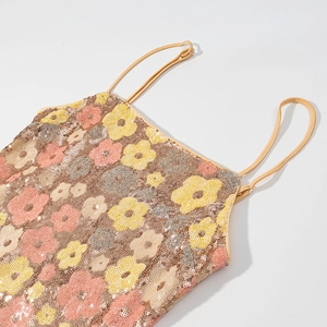 Detail of floral sequin embroidery with pink and yellow petals on a camisole top