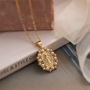 Close-up of gold plated Virgin Mary pendant featuring white pearl border on cross chain