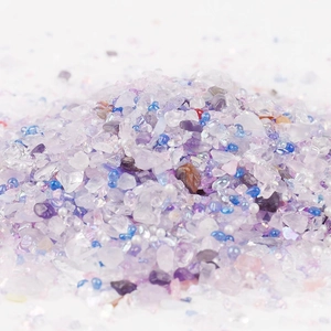 Close-up of mixed purple glass chips with white pearls for DIY handicraft decoration